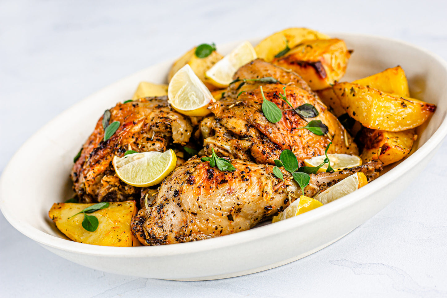 Greek,Lemon,Chicken,With,Potatoes,In,A,Bowl,On,White