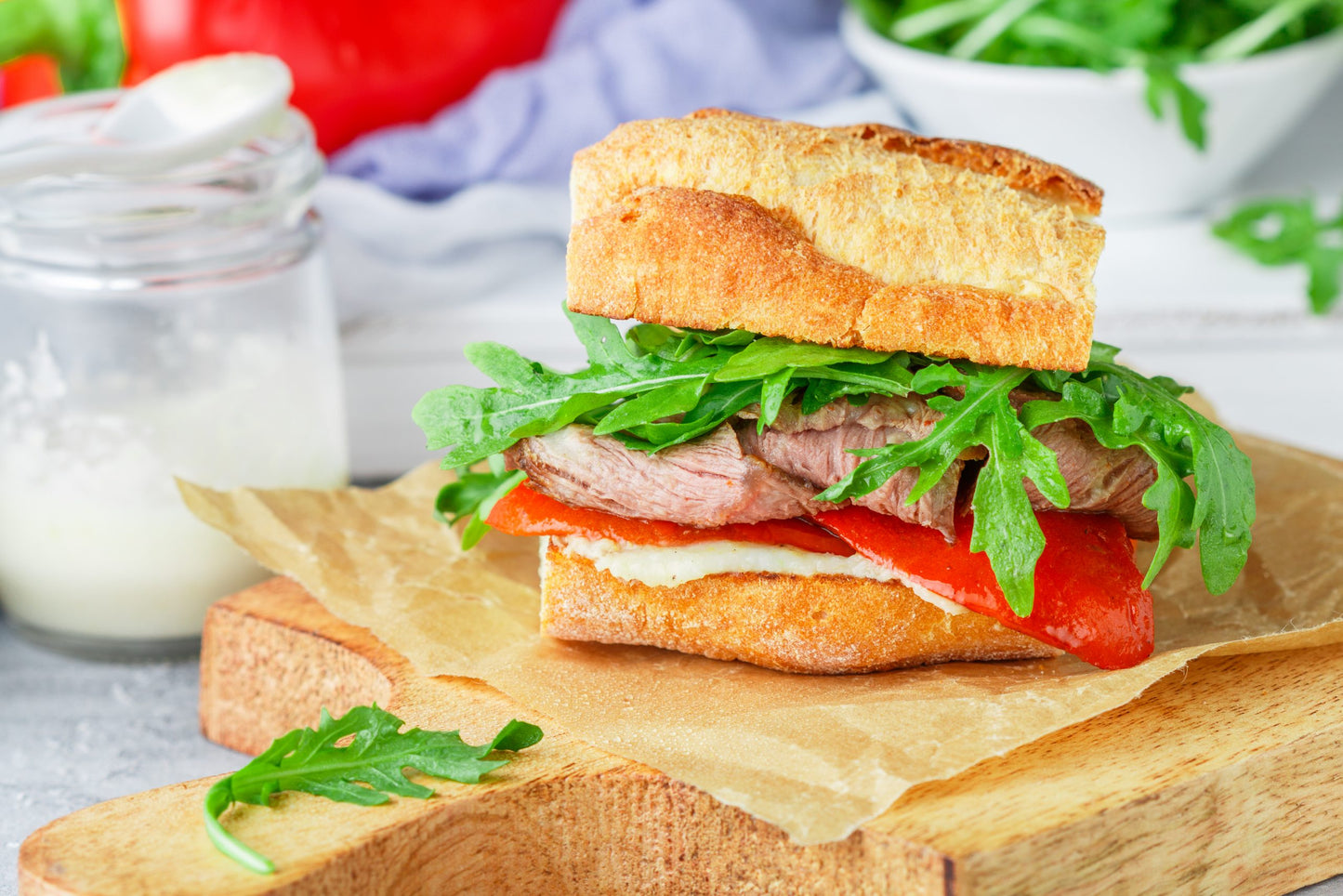 Delicatessen,Sandwich,With,Beef,,Baked,Red,Bell,Peppers,,Arugula,And